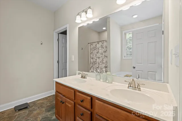 a bathroom with a bathtub sink and mirror