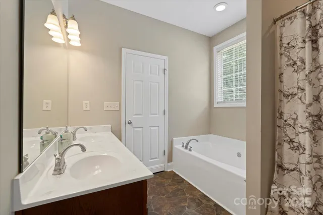 a bathroom with a bathtub and shower