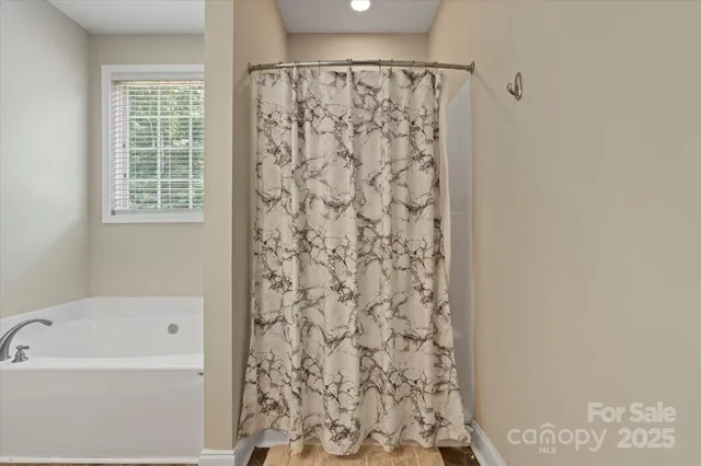 a white toilet sitting next to a white wall