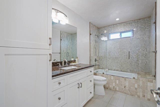13685 Quito Road Saratoga, CA 95070 - Photo 15 of 20 a bathroom with a double vanity sink toilet mirror and shower