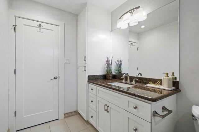 13685 Quito Road Saratoga, CA 95070 - Photo 16 of 20 a bathroom with a granite countertop sink and a mirror