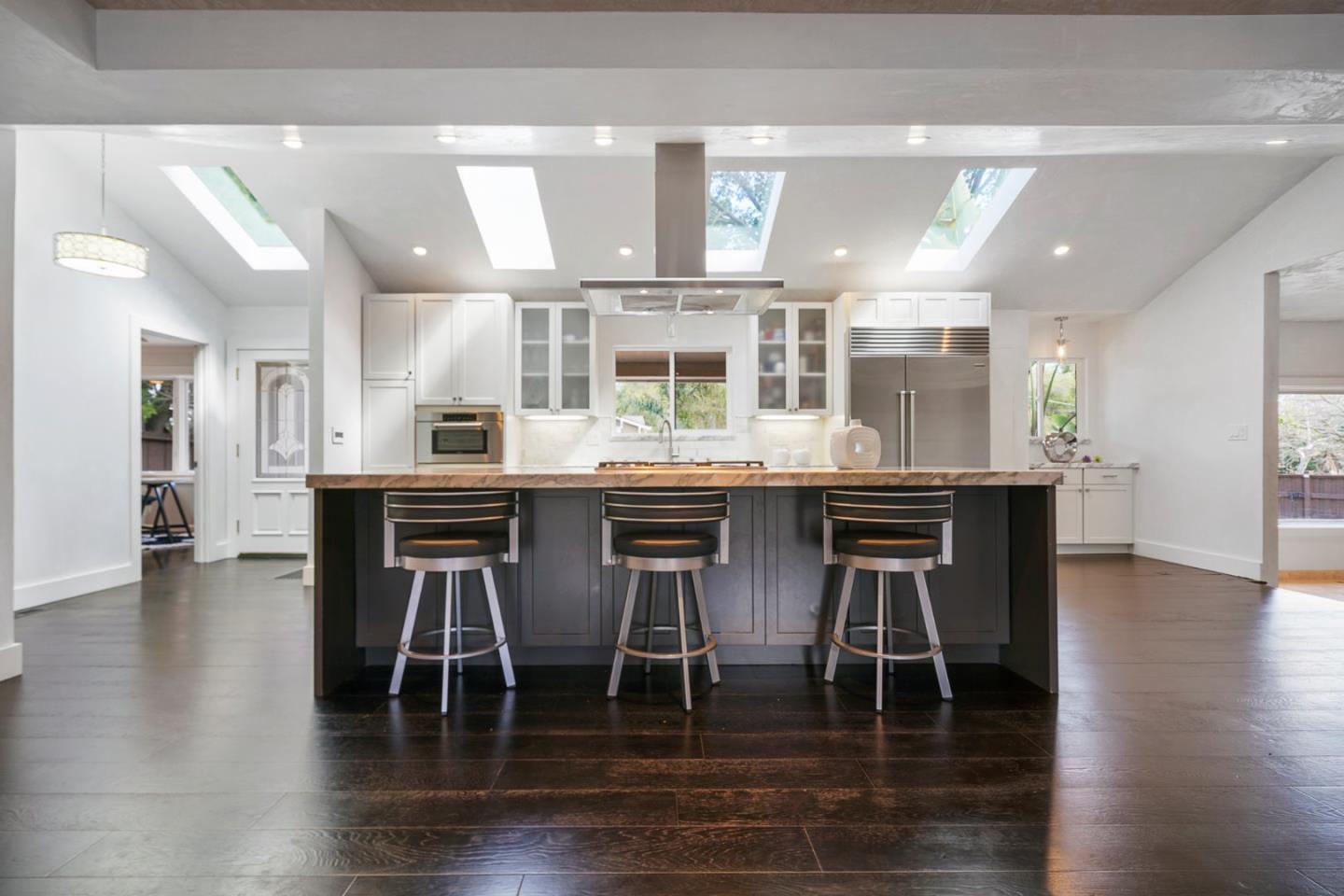 13685 Quito Road Saratoga, CA 95070 - Photo 7 of 20 a kitchen with stainless steel appliances granite countertop a table and chairs in it