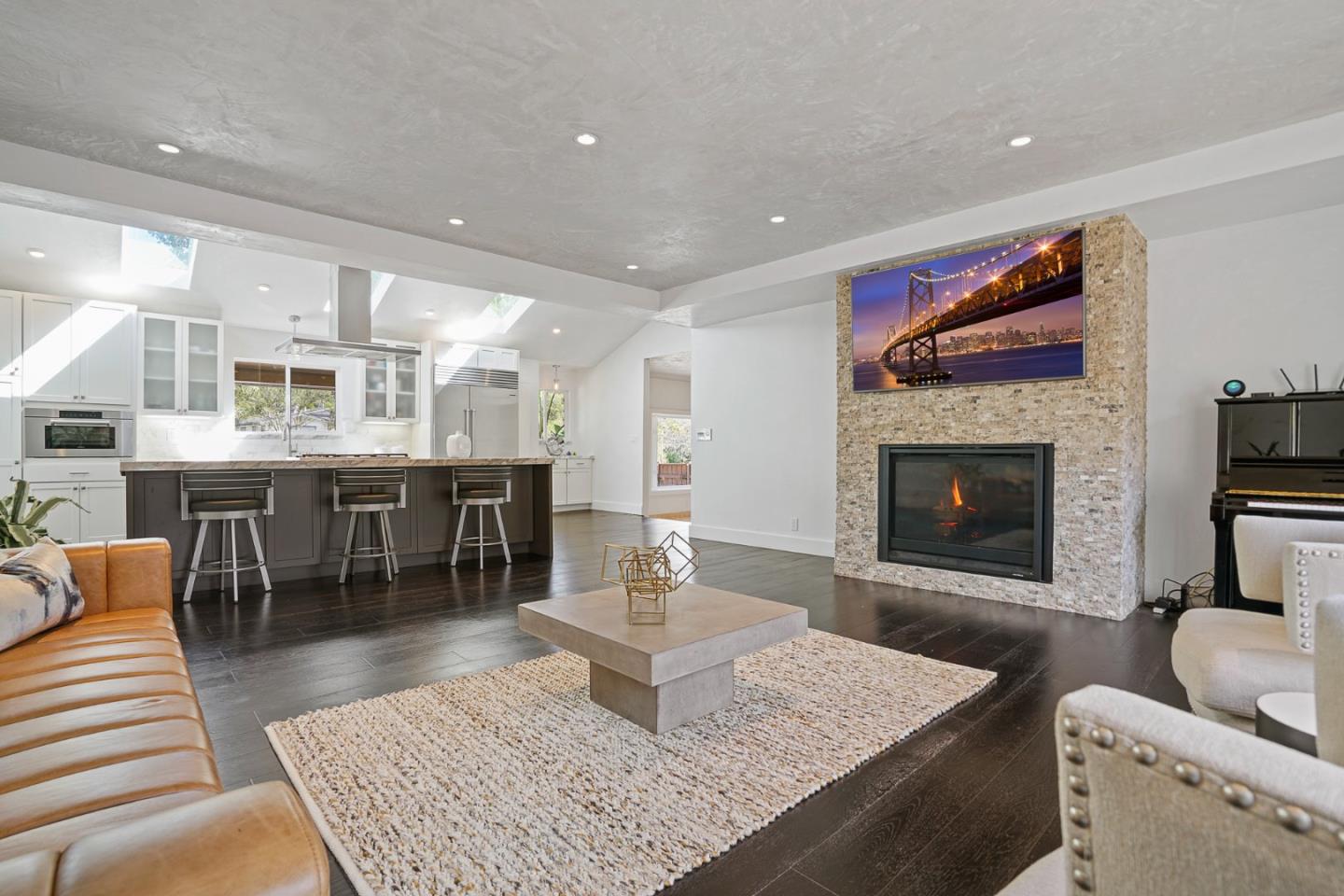 13685 Quito Road Saratoga, CA 95070 - Photo 9 of 20 a living room with stainless steel appliances furniture a rug and a fireplace