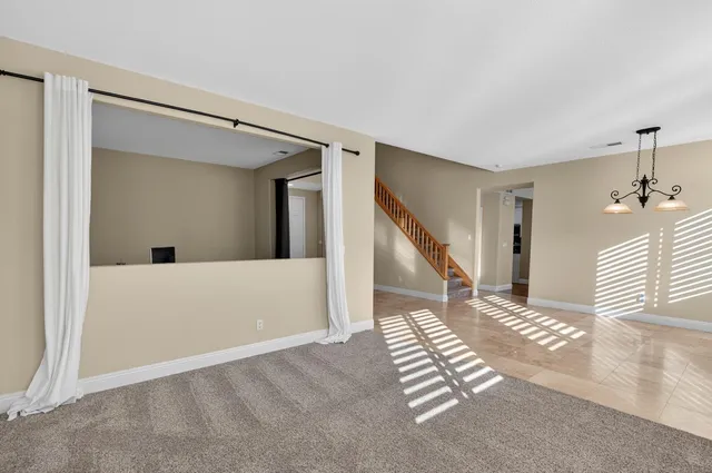 a view of a dining room with a table and chairs