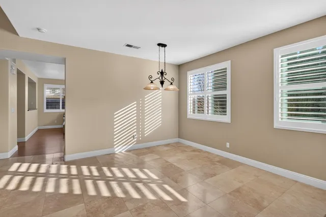 a kitchen with a table chairs refrigerator and microwave