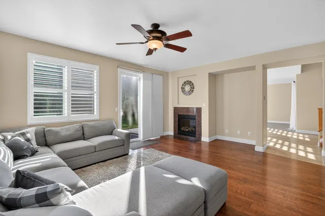 a kitchen with granite countertop a sink and white cabinets with wooden floor