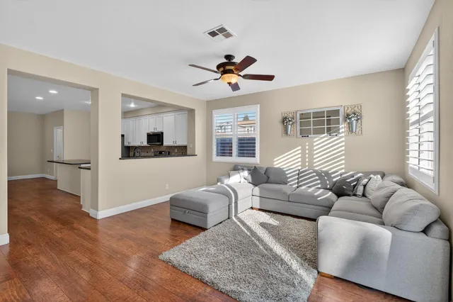 a living room with furniture or kitchen view and a wooden floor
