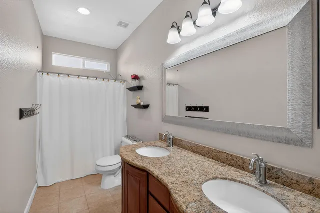 a view of backyard with swimming pool and outdoor seating