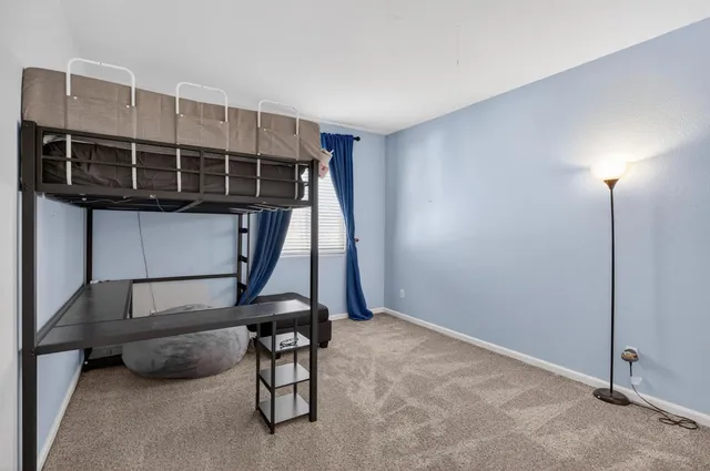 a view of an house with backyard and a tree