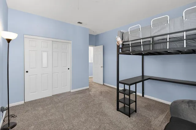 a view of a house with backyard and porch