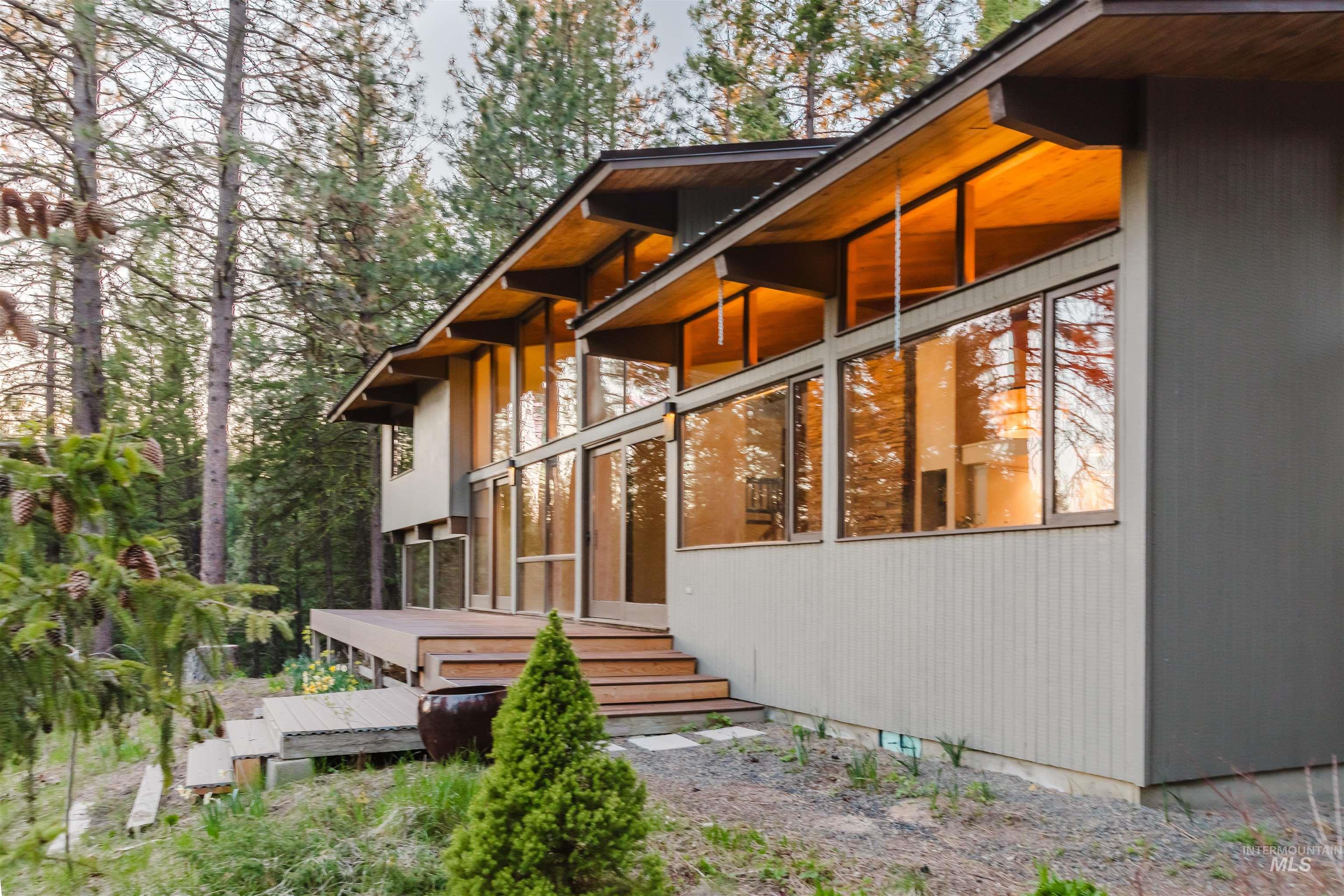 136 Silver Fox Trail McCall, ID 83638 - Photo 29 of 29 Contemporary architectural design featuring extensive window walls, a multi-level wood deck, and exposed wood eaves