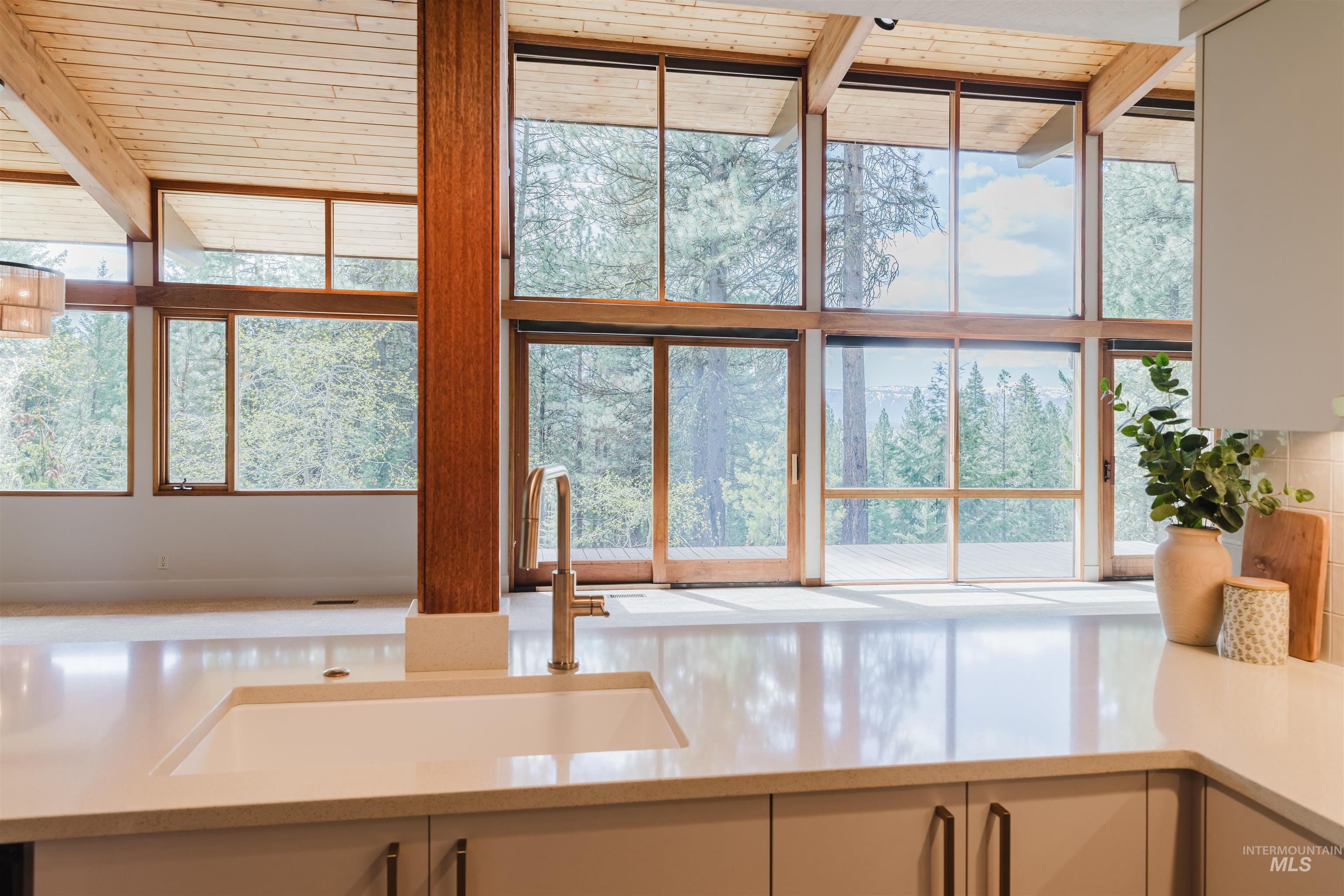 136 Silver Fox Trail McCall, ID 83638 - Photo 10 of 29 Kitchen featuring a large integrated sink, brushed metal faucet, light-toned countertops, and neutral cabinetry