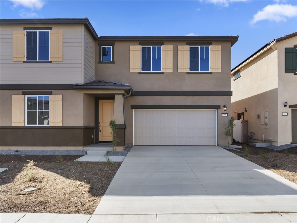 19557 Hanging Rock Road Lake Elsinore, CA 92532 - Photo 1 of 54 a front view of a house with a yard