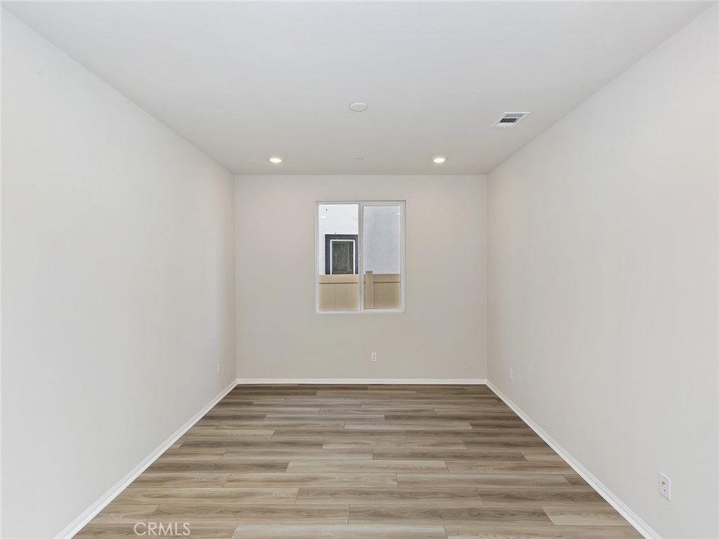 19557 Hanging Rock Road Lake Elsinore, CA 92532 - Photo 12 of 54 a view of empty room with wooden floor