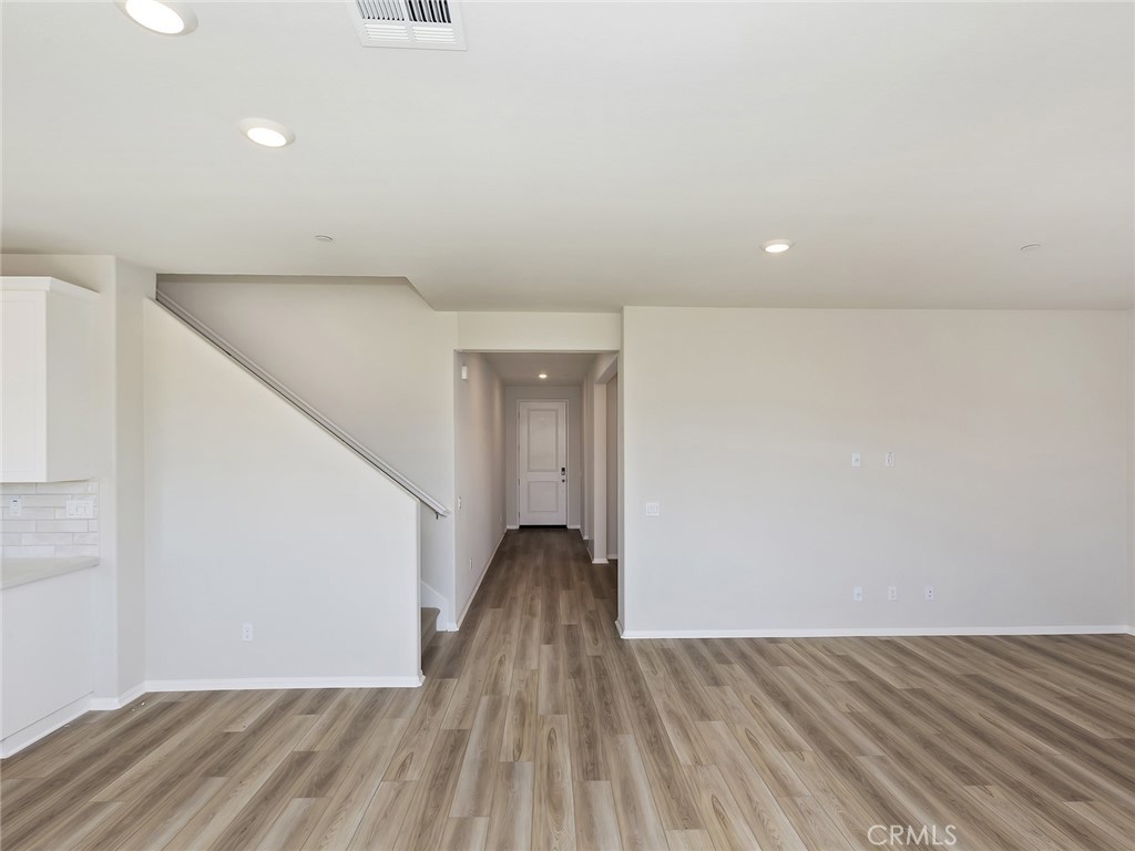 19557 Hanging Rock Road Lake Elsinore, CA 92532 - Photo 15 of 54 a view of an empty room with wooden floor
