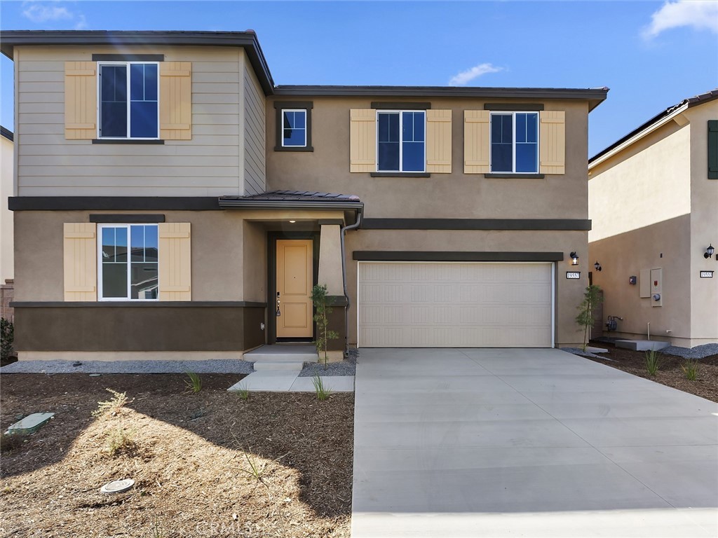 19557 Hanging Rock Road Lake Elsinore, CA 92532 - Photo 2 of 54 a front view of a house with a yard and garage