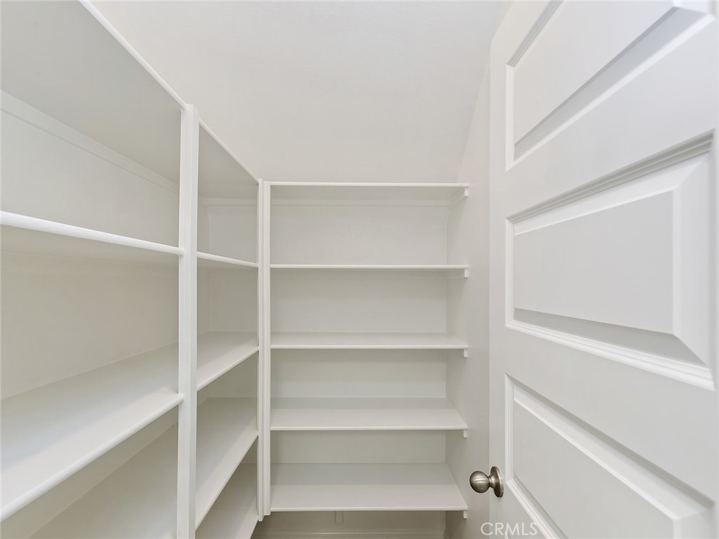 19557 Hanging Rock Road Lake Elsinore, CA 92532 - Photo 23 of 54 a view of walk in closet with empty racks