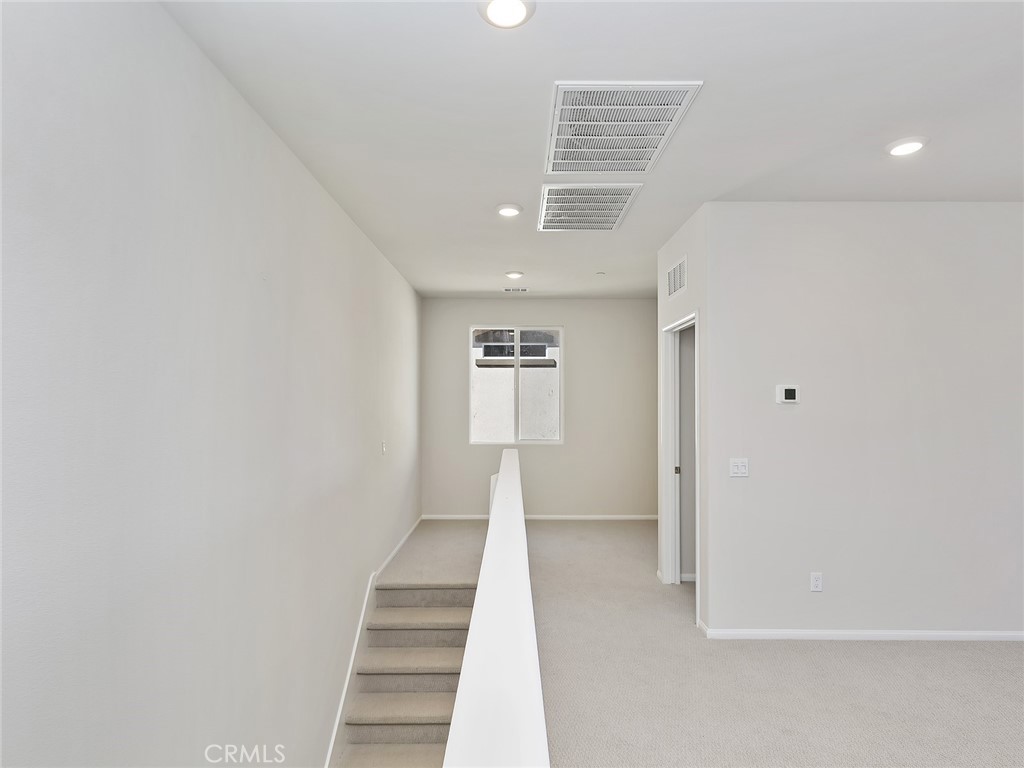 19557 Hanging Rock Road Lake Elsinore, CA 92532 - Photo 30 of 54 a view of an empty room with wooden floor and stairs