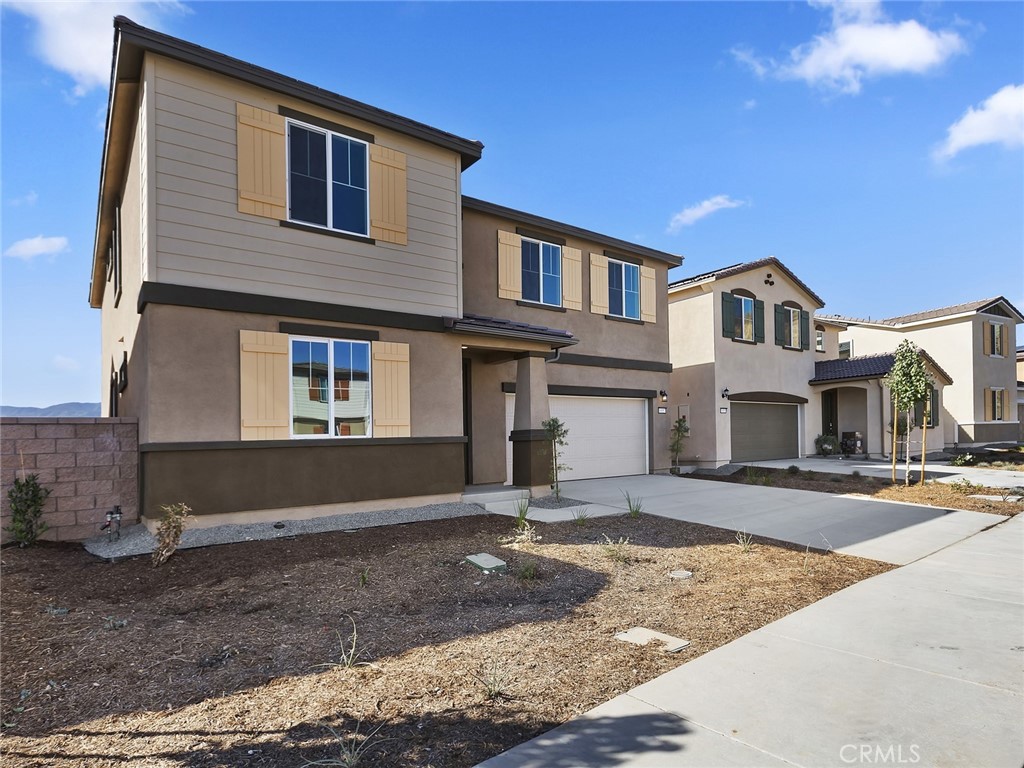 19557 Hanging Rock Road Lake Elsinore, CA 92532 - Photo 3 of 54 a front view of a house with a yard