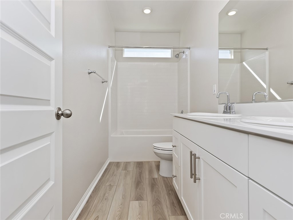 19557 Hanging Rock Road Lake Elsinore, CA 92532 - Photo 32 of 54 a bathroom with a sink a toilet and shower
