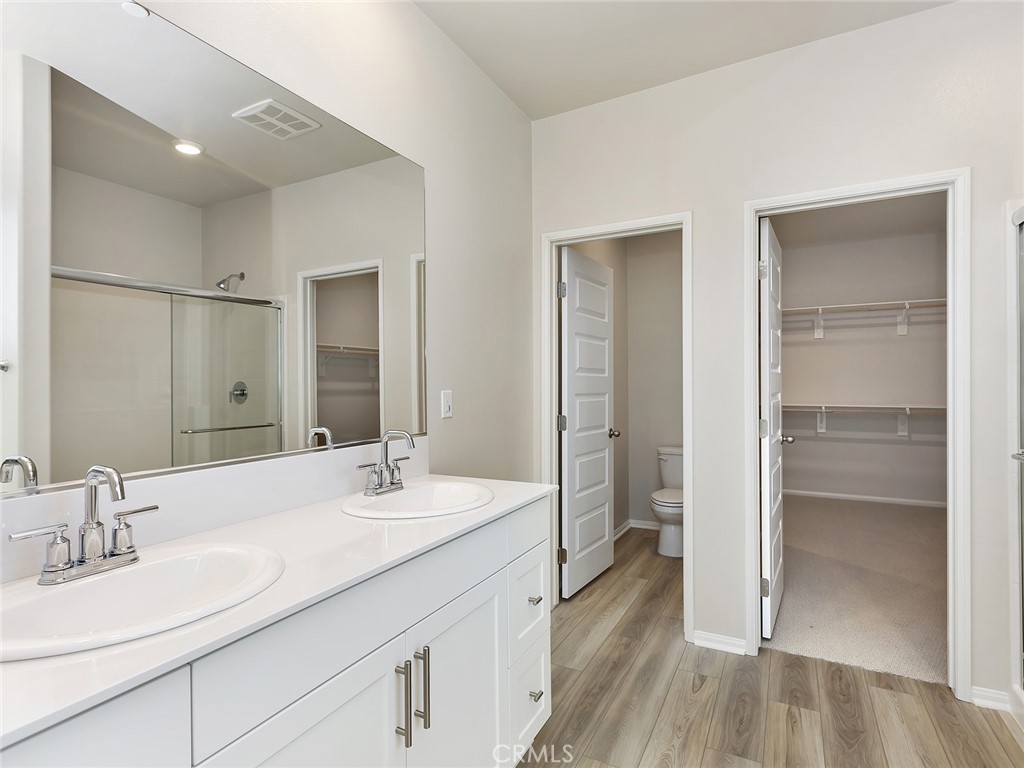 19557 Hanging Rock Road Lake Elsinore, CA 92532 - Photo 39 of 54 a bathroom with a double vanity sink mirror and shower