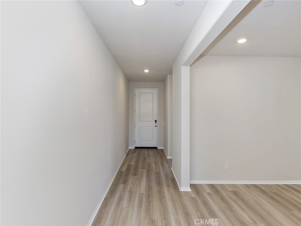19557 Hanging Rock Road Lake Elsinore, CA 92532 - Photo 7 of 54 a view of a hallway with wooden floor
