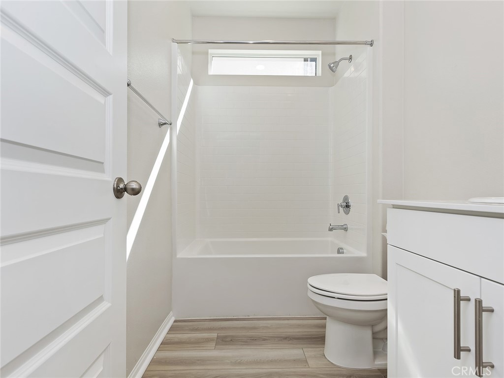 19557 Hanging Rock Road Lake Elsinore, CA 92532 - Photo 10 of 54 a bathroom with a toilet and a bath tub