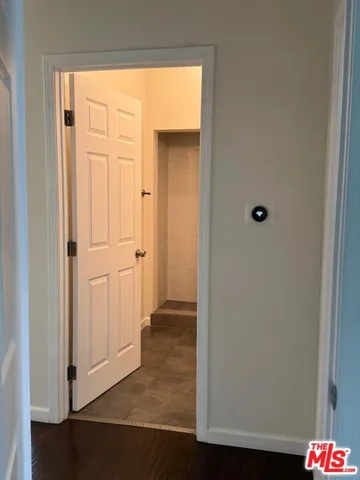 an entryway with a floor to ceiling window and wooden floor