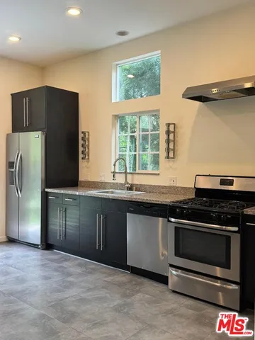 an empty room with wooden floor and natural light