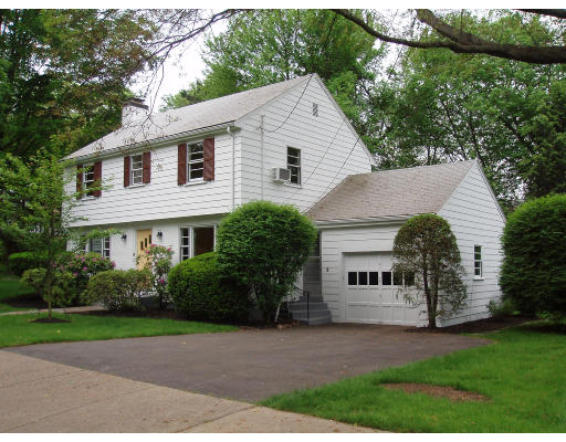 70 Boulder Road Newton, MA 02459 - Photo 2 of 12 a view of a white house next to a yard with big trees