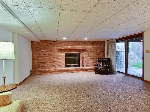 724 Timber Ridge Trail Rockford, IL 61114 - Photo 16 of 21 a view of a livingroom with furniture flat screen tv and a garage