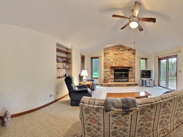 724 Timber Ridge Trail Rockford, IL 61114 - Photo 3 of 21 a living room with furniture a fireplace and a chandelier