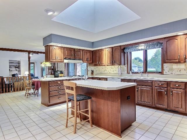724 Timber Ridge Trail Rockford, IL 61114 - Photo 8 of 21 a kitchen with stainless steel appliances granite countertop a stove top oven a sink dishwasher and cabinets