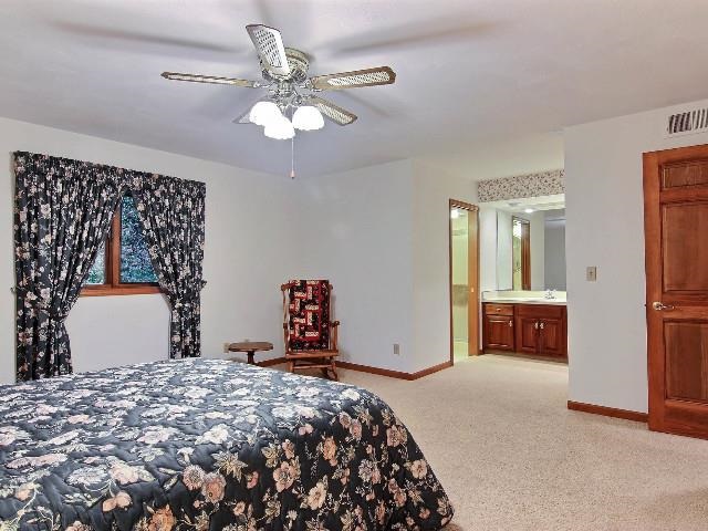 724 Timber Ridge Trail Rockford, IL 61114 - Photo 10 of 21 a bedroom with a bed and a chandelier