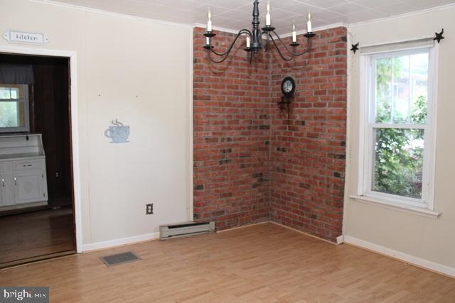 14611 Roosevelt Avenue Cascade, MD 21719 - Photo 3 of 20 a view of a brick wall next to a window