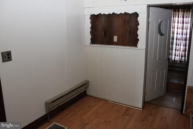 14611 Roosevelt Avenue Cascade, MD 21719 - Photo 4 of 20 an empty room with wooden floor and a window