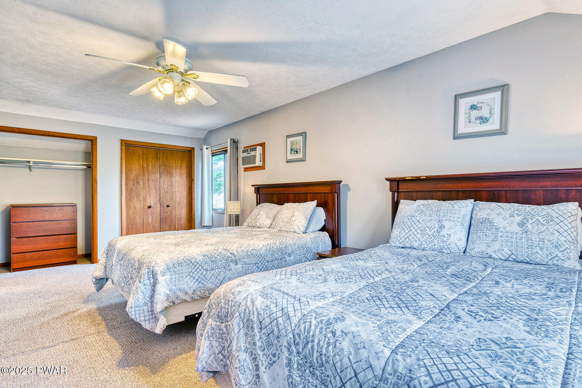 242 Northgate Road Lake Ariel, PA 18436 - Photo 32 of 85 a bedroom with two beds and a chandelier