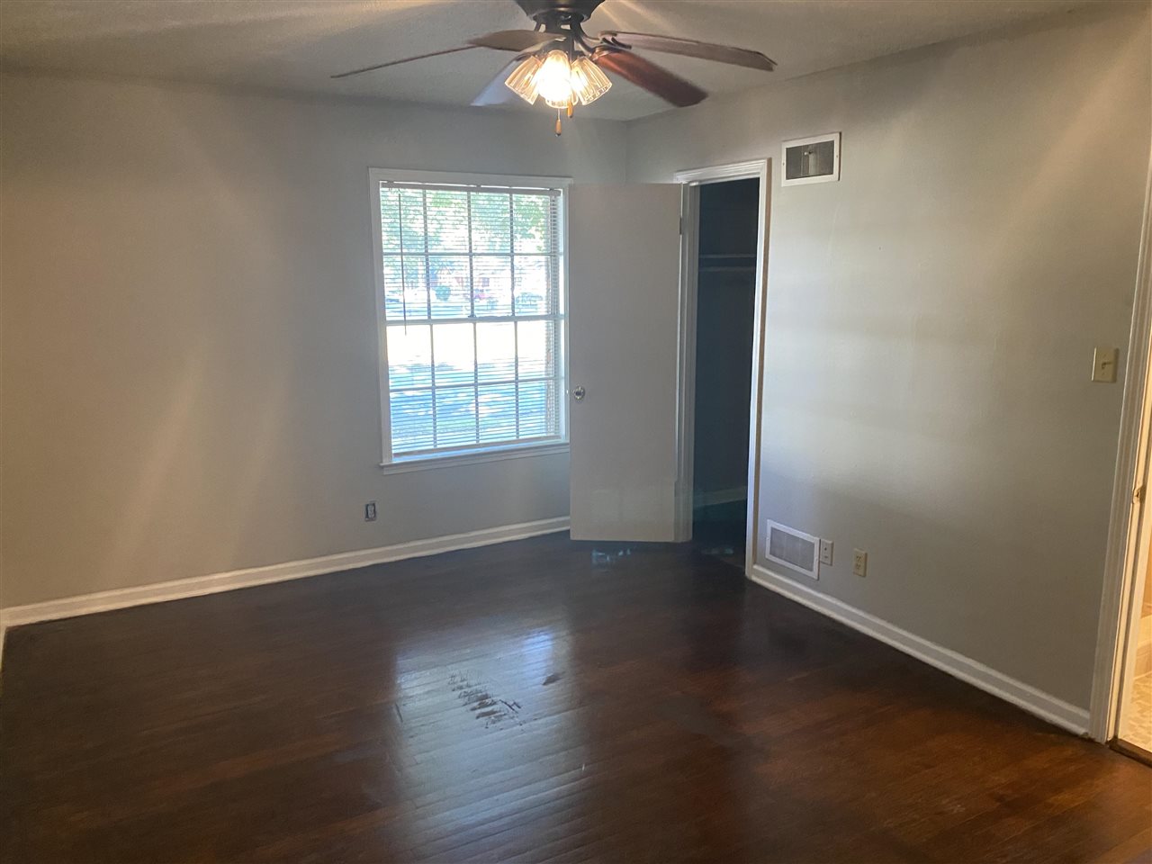 4066 Bishops Bridge Road Memphis, TN 38118 - Photo 12 of 19 an empty room with wooden floor chandelier fan and windows