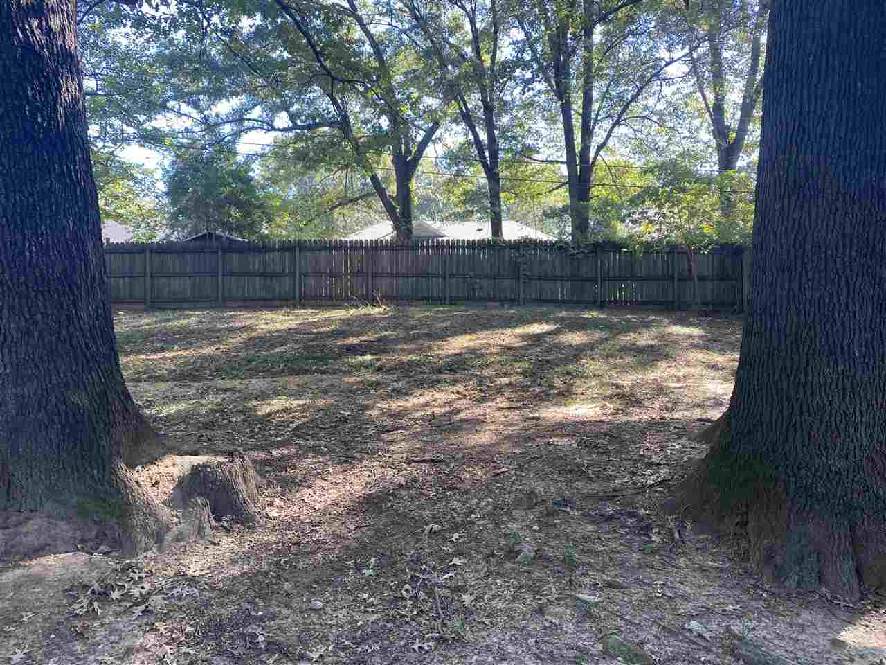 4066 Bishops Bridge Road Memphis, TN 38118 - Photo 17 of 19 a view of a yard with large trees and wooden fence