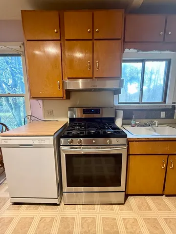a stove top oven sitting inside of a kitchen