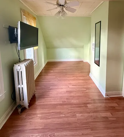 a view of a livingroom with wooden floor and a flat screen tv