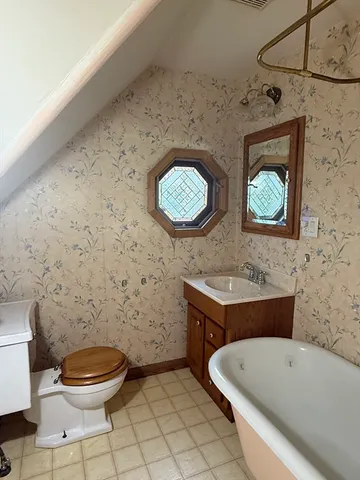a bathroom with a toilet a sink and bathtub
