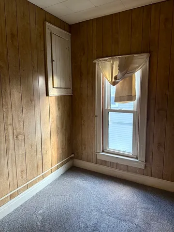 a view of a room with an empty space and a window