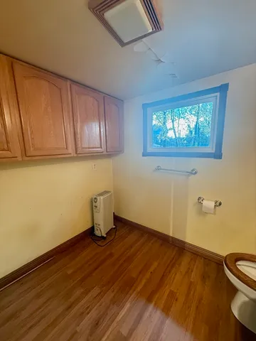 a bathroom with a sink a toilet and mirror