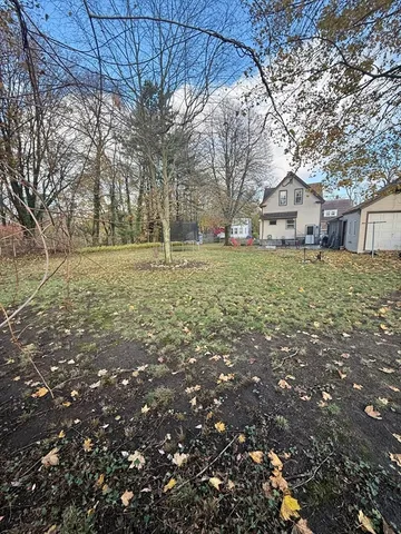 a big yard with large trees