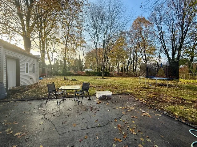 a view of a yard with table and chairs