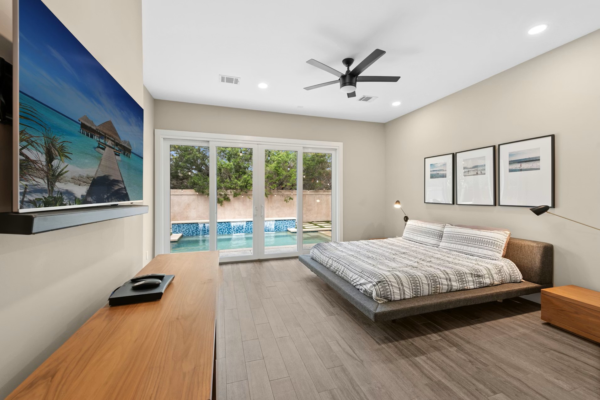 320 El Socorro Lane Austin, TX 78732 - Photo 5 of 40 a bedroom with a bed and wooden floor