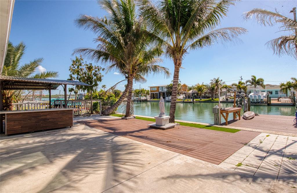 551 Crystal Drive Madeira Beach, FL 33708 - Photo 15 of 46 a view of a lake with a house and a big yard