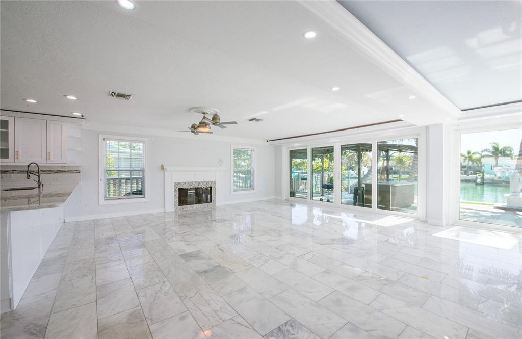 551 Crystal Drive Madeira Beach, FL 33708 - Photo 18 of 46 a view of an empty room with a fireplace and a window