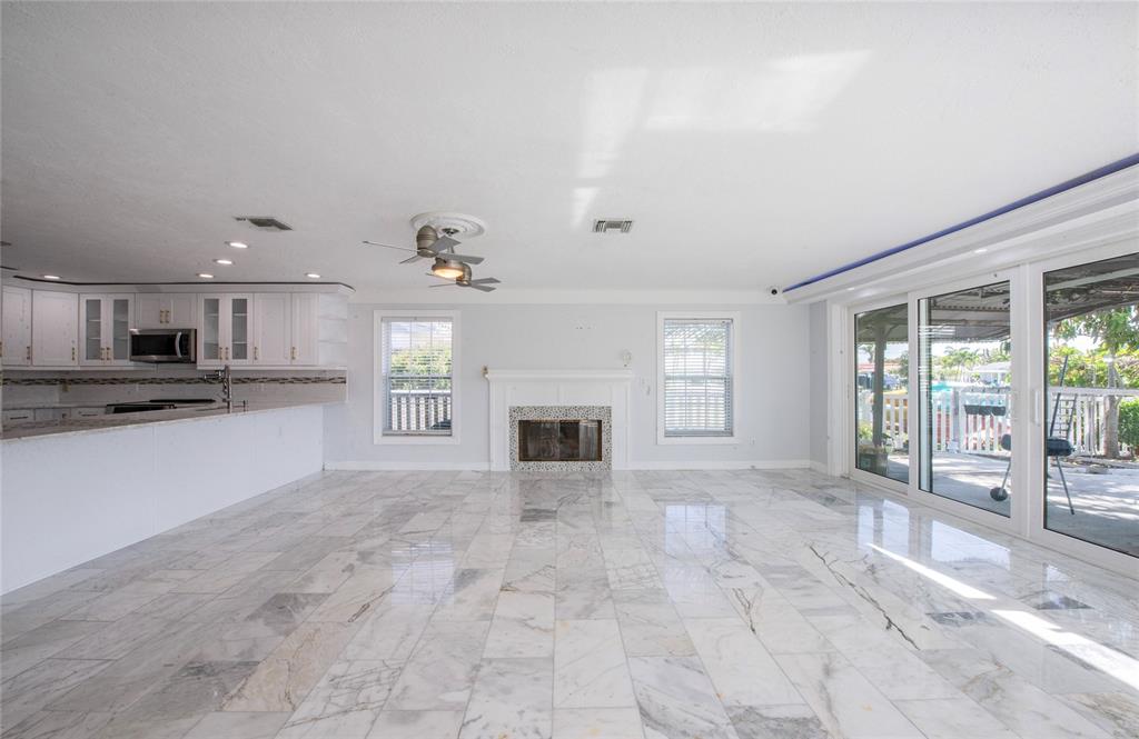 551 Crystal Drive Madeira Beach, FL 33708 - Photo 19 of 46 a big room with chandelier and fireplace